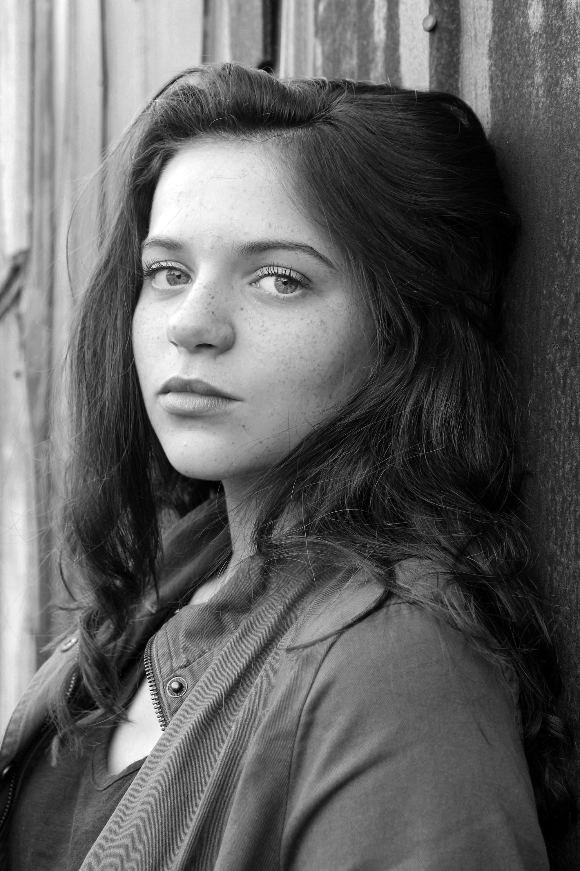 Black and white portrait of a young woman looking into the lens