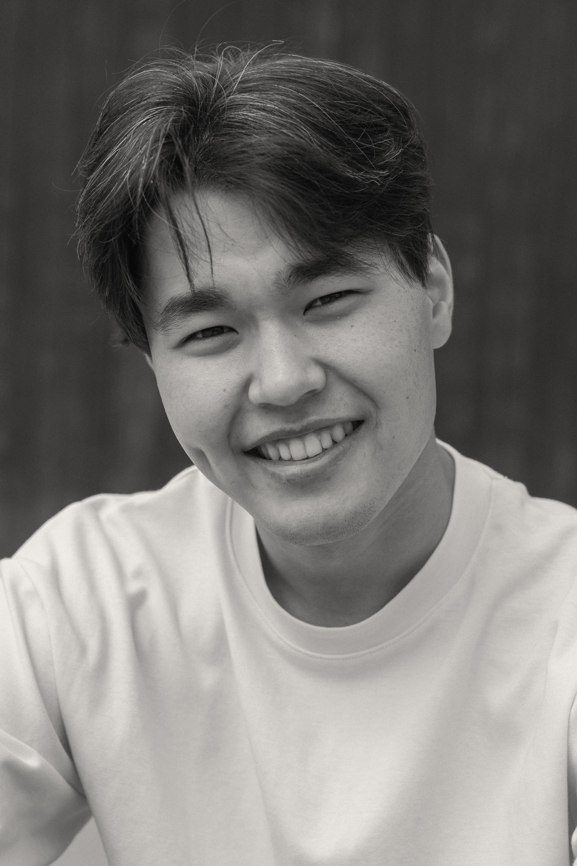 A young man laughing, close and candid